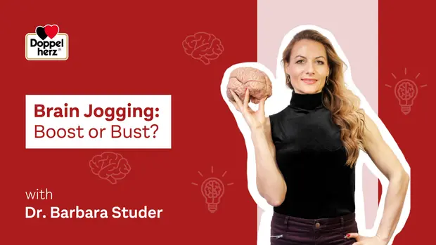 A woman holds a brain model and stands confidently, wearing a black top. The text reads "Brain Jogging: Boost or Bust?" with a mention of Dr. Barbara Studer. Background elements include lightbulb icons, emphasizing ideas or insights related to mental exercise.